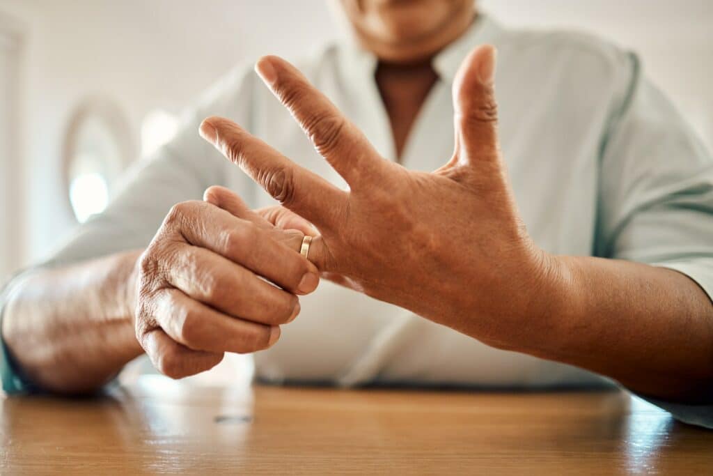Divorce, ring and hand of old woman at home for separation, breakup and conflict. Marriage problem,